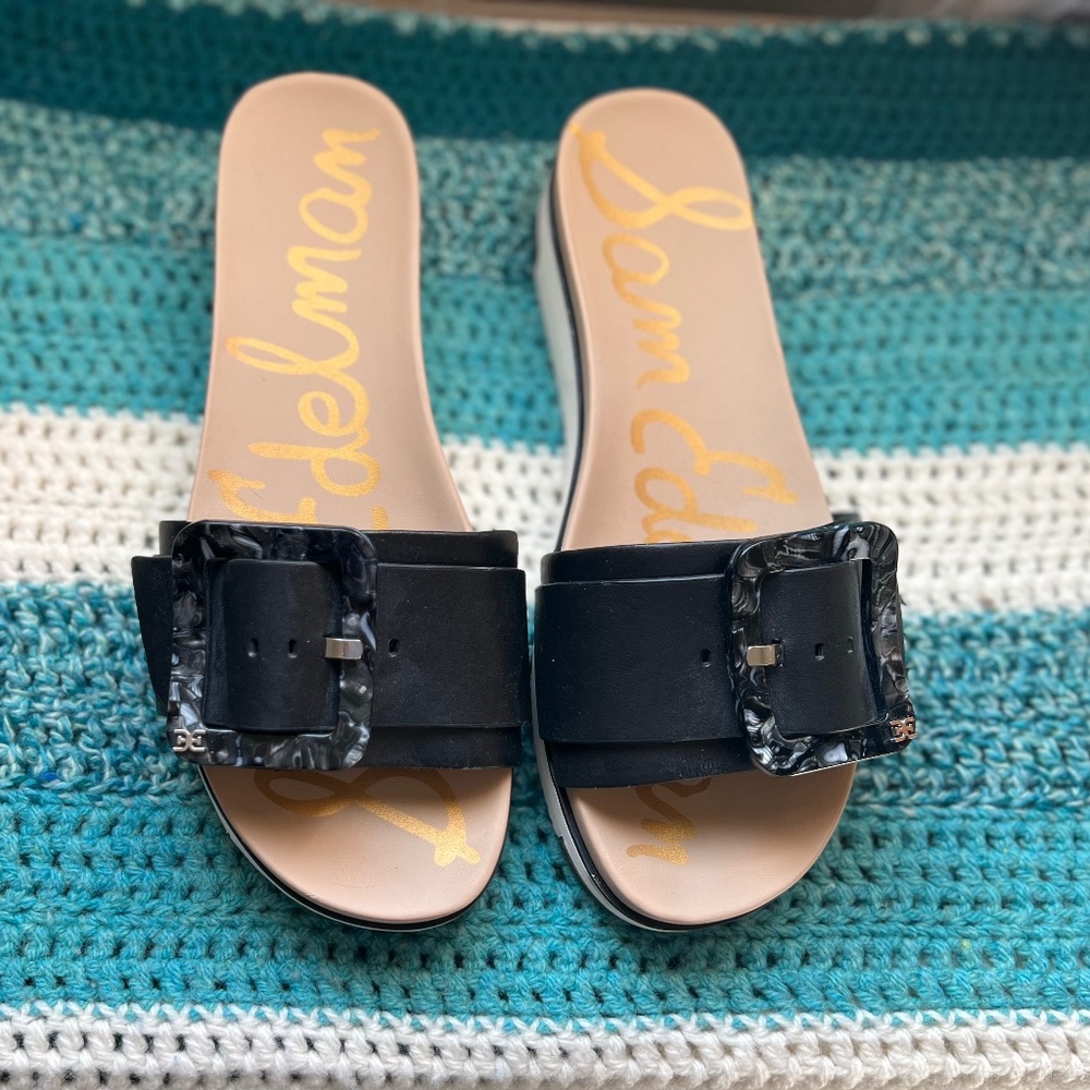 Sam Edelman slide with black leather upper decor buckle, and white sole.